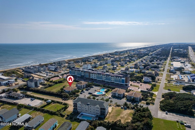 bird's eye view featuring a water view and a beach view