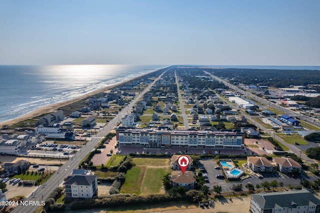 birds eye view of property featuring a water view and a beach view