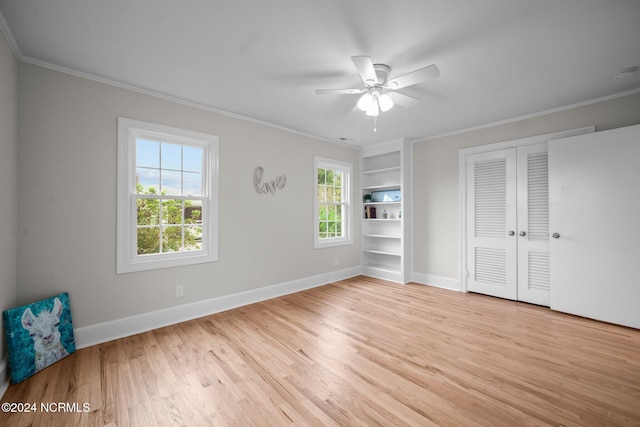 unfurnished bedroom featuring ornamental molding, multiple windows, light wood-type flooring, and ceiling fan