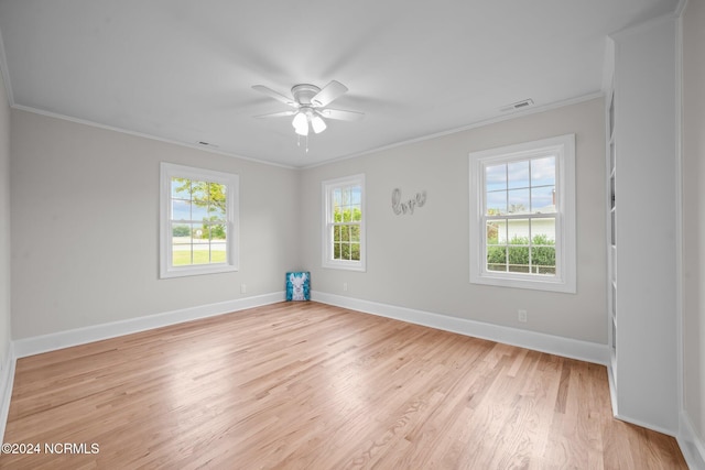 unfurnished room featuring ornamental molding, ceiling fan, plenty of natural light, and light wood-type flooring