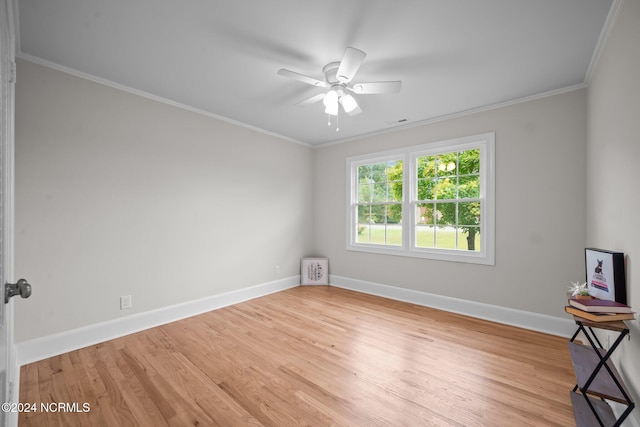 unfurnished room featuring crown molding, light wood-type flooring, and ceiling fan