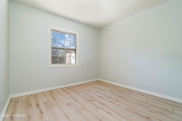 spare room with light hardwood / wood-style flooring