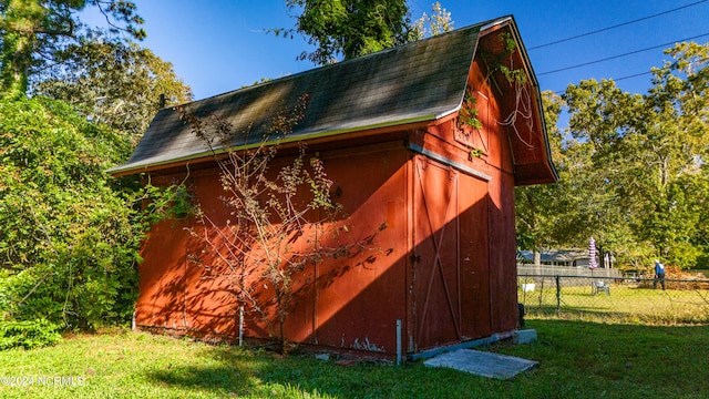 view of outdoor structure with a lawn