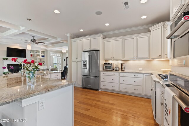 kitchen with white cabinets, light wood-style floors, visible vents, and stainless steel appliances