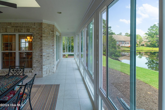 unfurnished sunroom with a water view