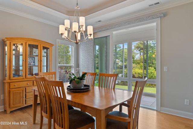 dining room with crown molding, visible vents, and light wood finished floors