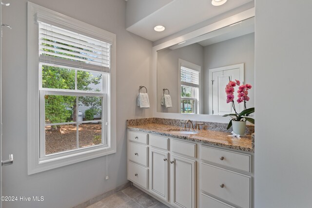 bathroom featuring tile patterned flooring, recessed lighting, and vanity