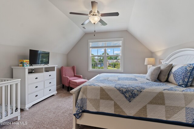 bedroom with visible vents, lofted ceiling, light colored carpet, and ceiling fan