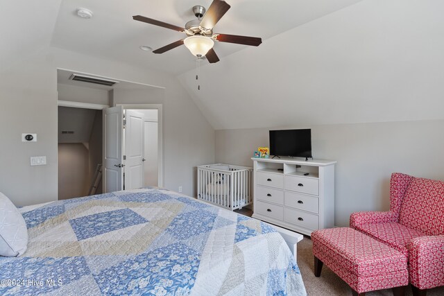 carpeted bedroom with lofted ceiling, visible vents, and ceiling fan