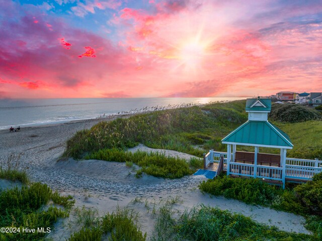 property view of water featuring a gazebo and a beach view