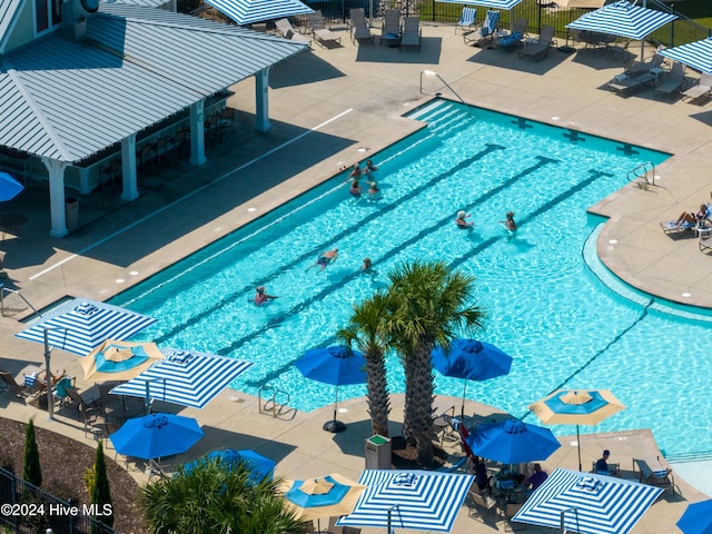 community pool featuring a patio and fence