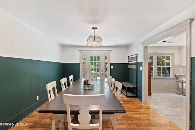 dining space featuring crown molding and light wood-type flooring