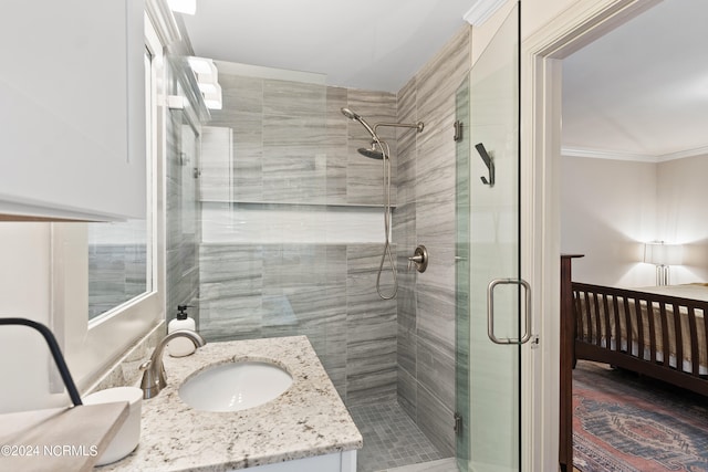 bathroom featuring vanity, crown molding, and a shower with shower door