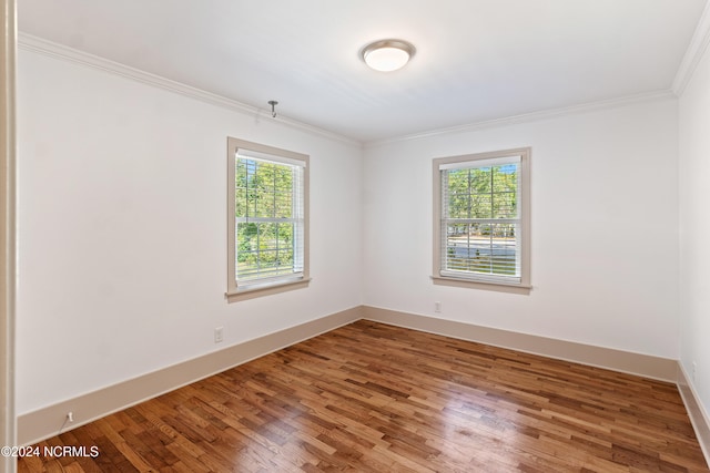 unfurnished room with crown molding and wood-type flooring