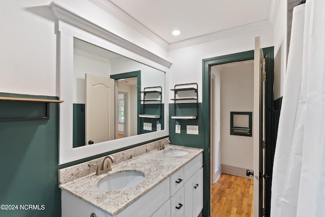 bathroom featuring vanity, crown molding, and hardwood / wood-style flooring