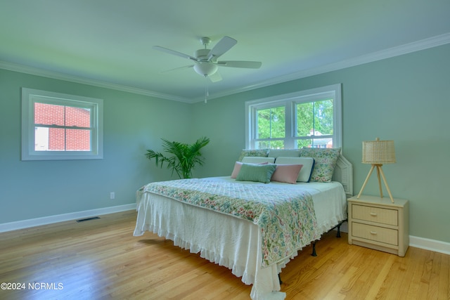 bedroom with ceiling fan, ornamental molding, and light hardwood / wood-style flooring