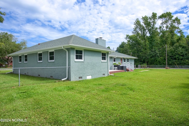 back of property featuring a yard