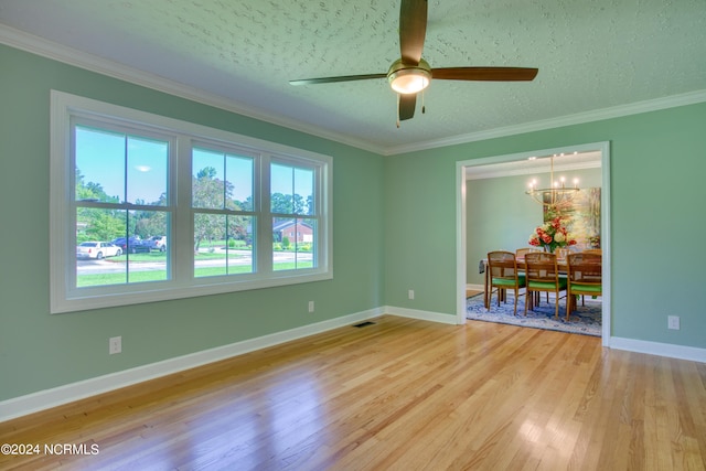 unfurnished room with ornamental molding, a textured ceiling, ceiling fan with notable chandelier, and light wood-type flooring