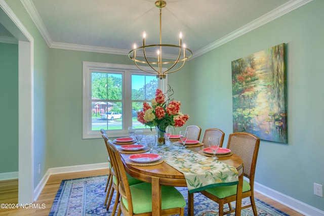 dining room featuring a notable chandelier, crown molding, and hardwood / wood-style flooring