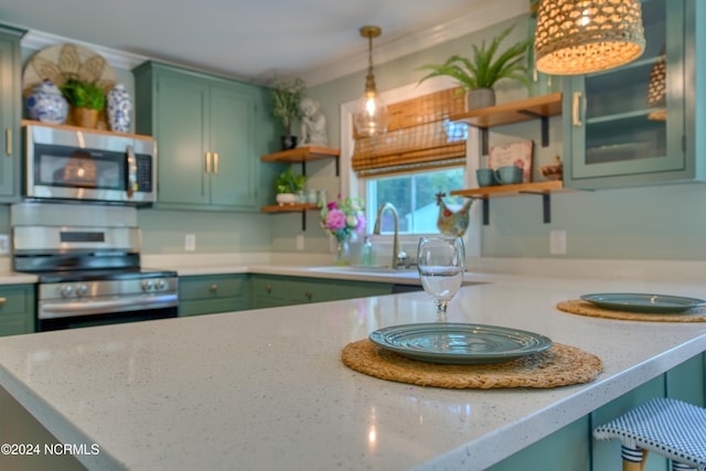 kitchen featuring light stone countertops, appliances with stainless steel finishes, green cabinets, decorative light fixtures, and ornamental molding