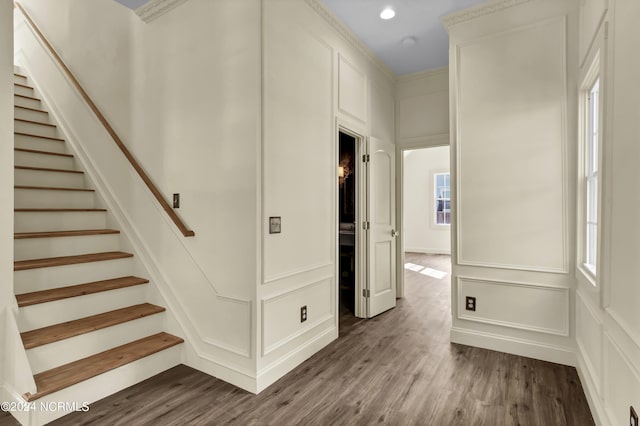 interior space with hardwood / wood-style floors and crown molding