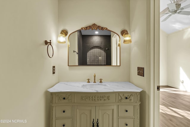 bathroom featuring hardwood / wood-style floors, vanity, and ceiling fan