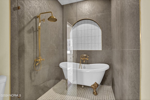 bathroom with shower with separate bathtub and tile walls