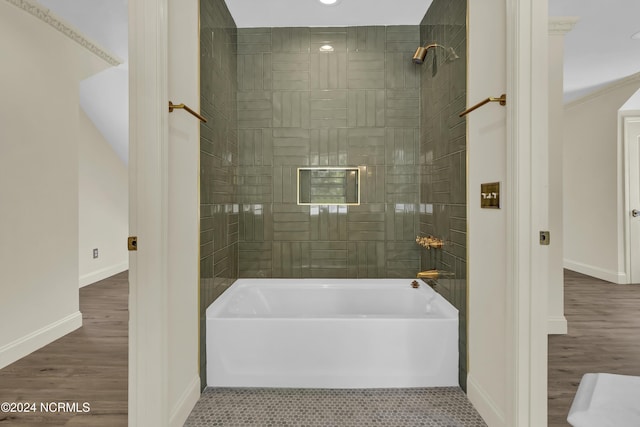 bathroom featuring tiled shower / bath combo and hardwood / wood-style flooring