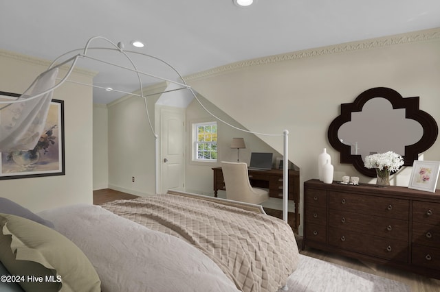 bedroom with light wood-type flooring and ornamental molding