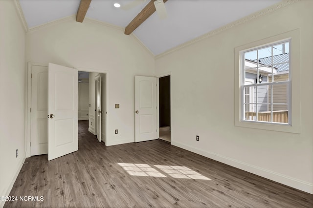 unfurnished bedroom featuring ceiling fan, ornamental molding, lofted ceiling with beams, and hardwood / wood-style flooring