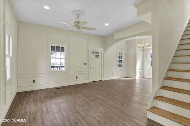 entrance foyer featuring wood-type flooring, ceiling fan with notable chandelier, and ornamental molding