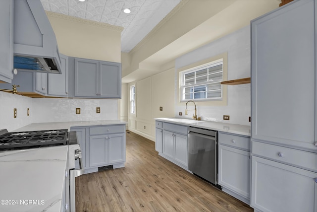 kitchen with stainless steel dishwasher, ornamental molding, extractor fan, sink, and light hardwood / wood-style floors