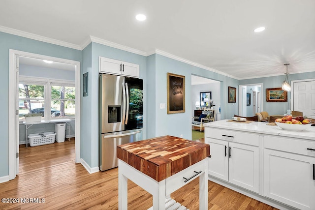 kitchen featuring light hardwood / wood-style floors, white cabinetry, decorative light fixtures, and stainless steel fridge with ice dispenser