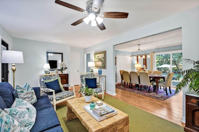 living room with hardwood / wood-style floors and ceiling fan