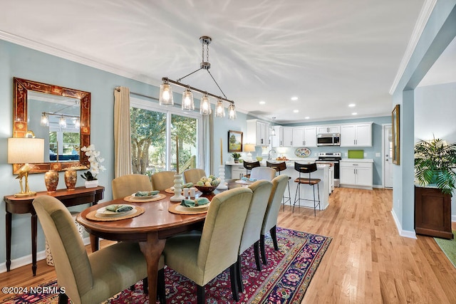 dining area with ornamental molding and light wood-type flooring