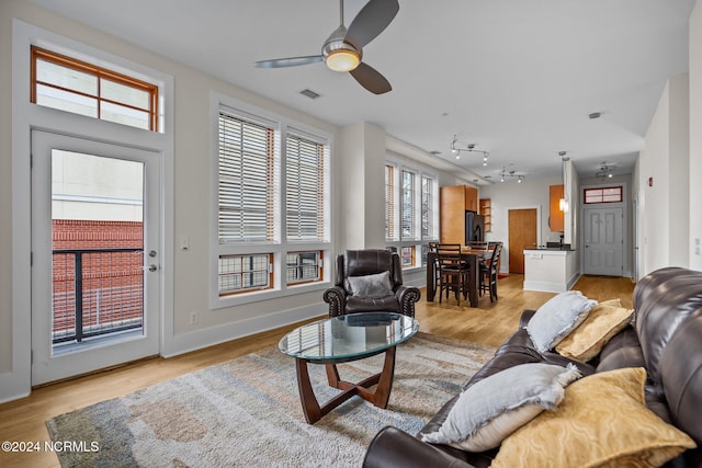 living room featuring ceiling fan and light wood-type flooring