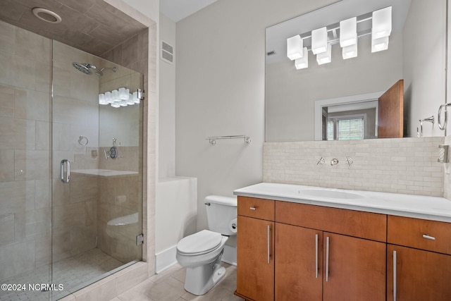 bathroom featuring tasteful backsplash, a shower with door, toilet, vanity, and tile patterned floors