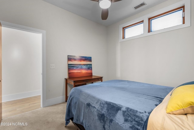 bedroom with light colored carpet and ceiling fan