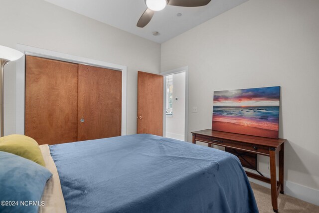 carpeted bedroom with a closet and ceiling fan