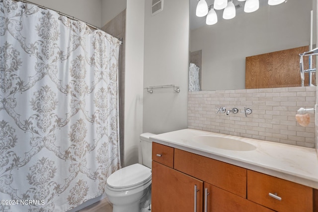 bathroom with vanity, a shower with shower curtain, and toilet