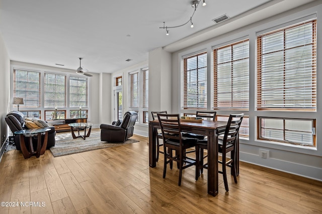 dining space with light hardwood / wood-style floors and ceiling fan