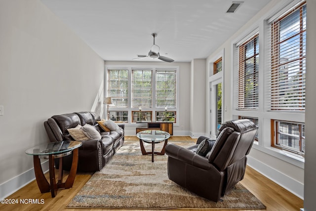 living room with light hardwood / wood-style flooring and ceiling fan