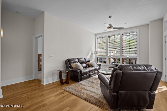 living room featuring ceiling fan and wood-type flooring