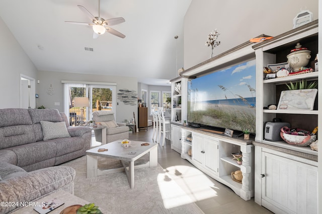 living room featuring ceiling fan and high vaulted ceiling