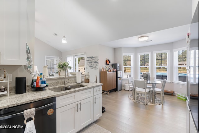 kitchen with white cabinetry, dishwasher, light stone countertops, and sink