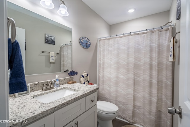 bathroom with vanity, toilet, and walk in shower