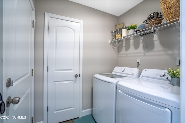 clothes washing area with washer and clothes dryer