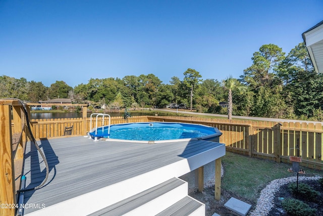 view of swimming pool featuring a deck with water view