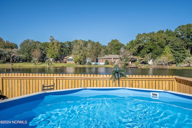 view of pool with a water view