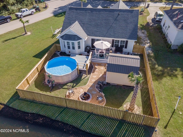 view of swimming pool with a yard, a patio area, and a shed